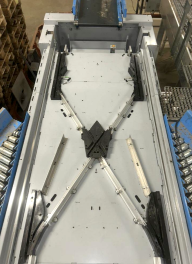 Overhead view of a clean automated conveyor diverter structure for a complex parcel sorting system.